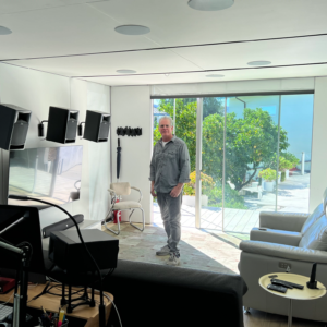 man surrounded by av equipment